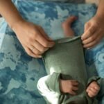 a person clothing a baby