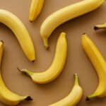 yellow banana fruits on brown surface