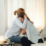 mother comforting crying daughter