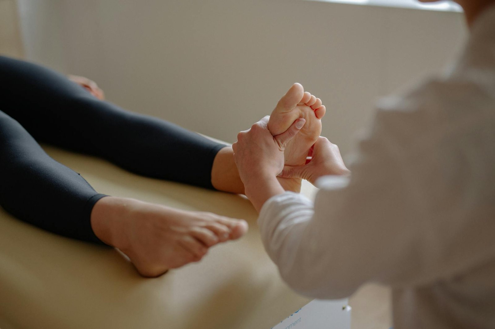 a person massaging a person s foot - bienfaits de l'acupression