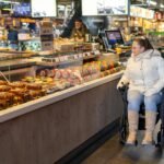 woman on wheelchair in supermarket - fauteuil roulant électrique